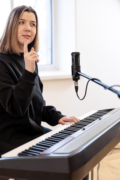 Professional vocal training instructor demonstrating proper singing technique during voice lessons
