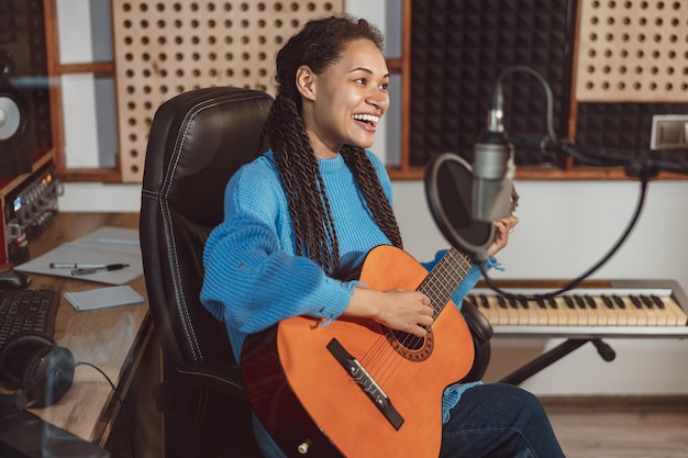 Student practicing vocal exercises with microphone in modern music studio setting